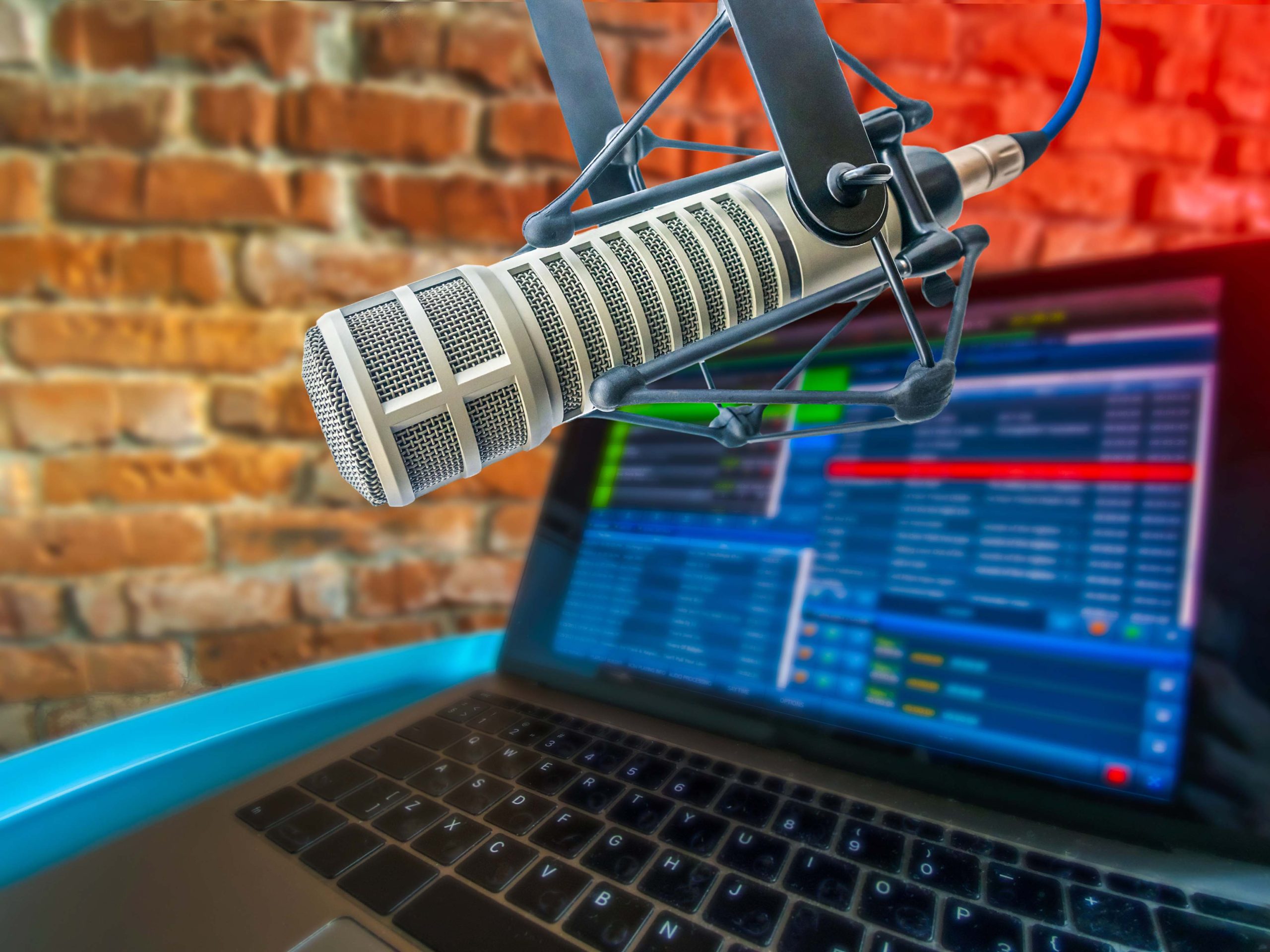 Photo of microphone and laptop in studio